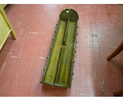 A vintage cast iron pig feeding trough marked 'H Hughes & Sons, Llangefni' (dividers missing)