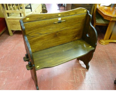 A neat 20th Century hall bench with peg jointed seat and sides and simple heart decoration, 95 cms high, 100 cms wide