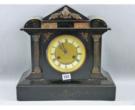 A black slate mantel clock in an architectural style case, the circular dial flanked by Corinthian columns and with pink marb