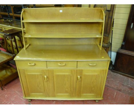 An Ercol style light wood sideboard with plate rack, approximately 120 cms wide