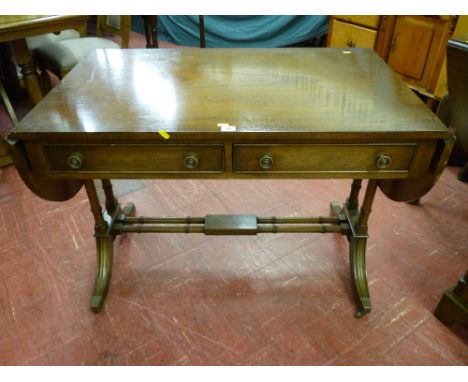 A good quality reproduction mahogany sofa table by Reprodux, two beaded edge drawers with decorative knobs, flanking 'D' end 