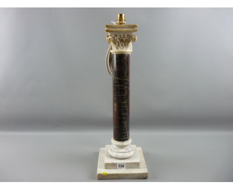 A Cornish serpentine stone column lamp with stepped marble base and carved Corinthian cap, 57 cms high, 18 cms base width (so