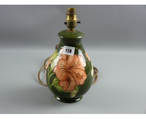 A Moorcroft pottery green ground 'Hibiscus' bulbous table lamp, 25 cms high