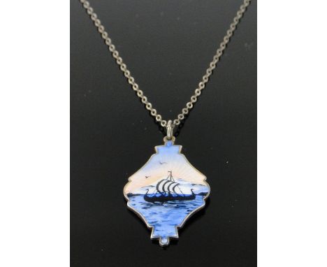 A Swedish silver and painted enamel pendant and chain
depicting a Viking long boat, pendant height 35mm.