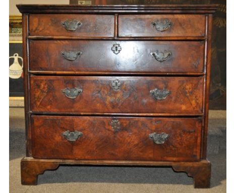 18th century figured walnut chest of drawers,
having a quarter veneer and crossbanded top with moulded edge, 2 short and 3 fu