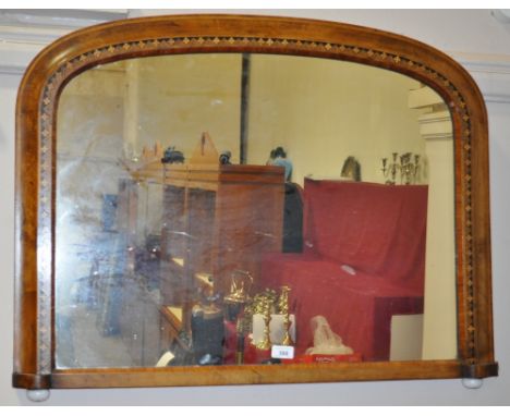 A Victorian walnut arched top over mantle mirror,
with inlaid banded decoration and ceramic feet, width 3', height 2'3.