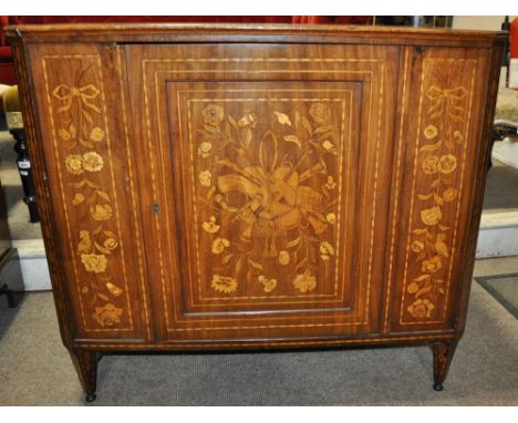 An Antique Dutch marquetry and mahogany cabinet,
with single panel door, raised on short tapered legs, marquetry panels depic