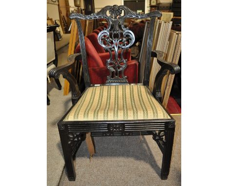 A 19th century Chippendale style carved mahogany open armchair.