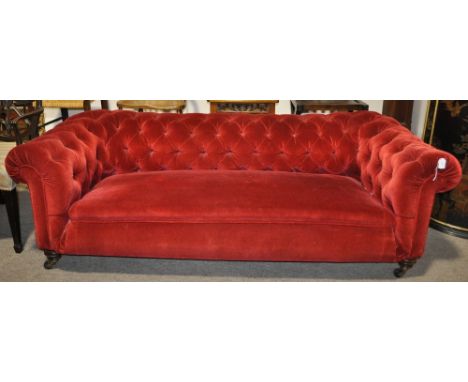 A Victorian button upholstered Chesterfield sofa
with turned mahogany legs, width 6'8, depth 2'10.
