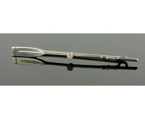 A diamond set rowing oar design lapel brooch,
unmarked gold and silver settings, length 60mm.