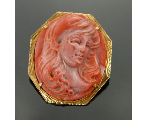 A relief-carved coral Cameo pendant/brooch,
18ct gold settings, height 38mm.