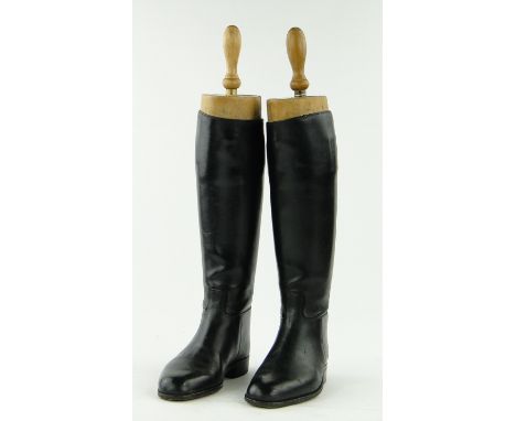 A pair of black leather hunting boots,
with wooden trees by Tom Hill, Knightsbridge, London.