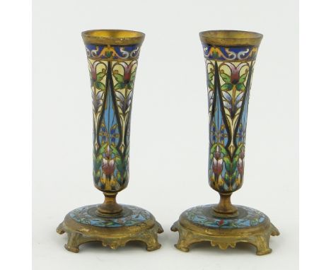 A pair of champleve enamel bud vases
circa 1900, with floral designs finished in gold, height 4".