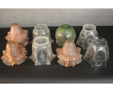 A collection of twelve Victorian etched glass lamp shades, including a set of six peach glass ripple rimmed shades and two cl