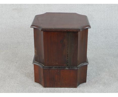 A 19th century mahogany commode, the lid with moulded edges and canted corners, raised on a plinth base. H.44 W.41 D.41cm 