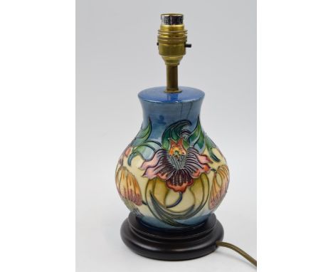 Moorcroft lamp in the Anna Lily pattern mounted onto wooden base, 27cm tall inc brass fittings.  In good condition with no ob