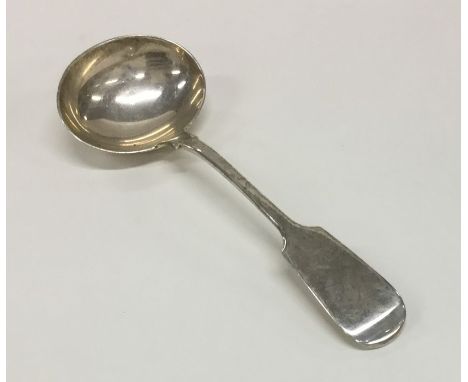 EXETER: A silver fiddle pattern sauce ladle. By JS. Approx. 53.7 grams. Est. £25 - £35.