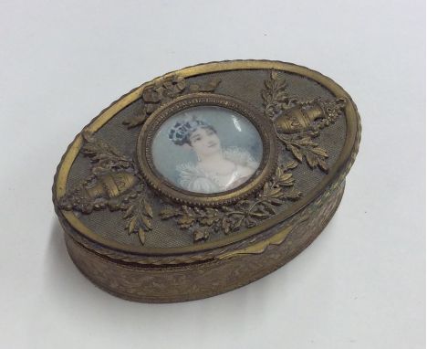 An attractive oval brass mounted snuff box with oval painted centre. Est. £20 - £30.