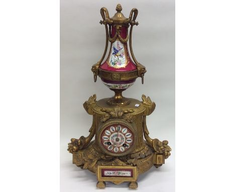 An attractive French mantle clock with floral decoration and porcelain panels to bracket feet. Est. £100 - £150.