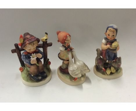 A group of three Goebel figures of children. Est. £20 - £30.
