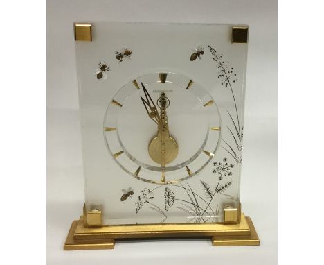 JAEGER LECOULTRE: A stylish glass and brass mounted mantle clock decorated with bees and flowers contained within a fitted bo