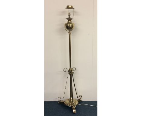 A tall brass lamp mounted with reservoir. Est. £60 - £80.