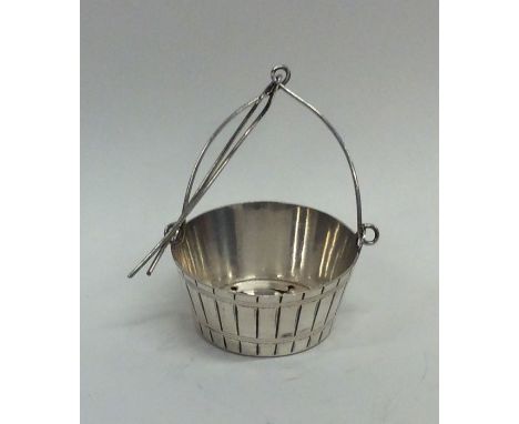 An unusual tea infuser in the form of a bucket with handle on suspension chain. Est. £10 - £20.