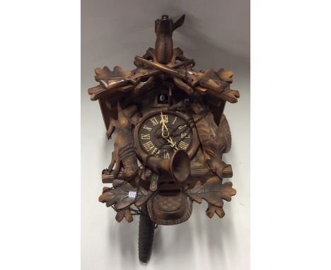 An old cuckoo clock of typical design complete with pendulum. Est. £25 - £35.