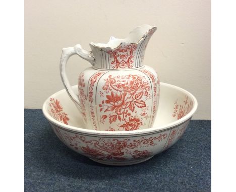 A large decorative gilt jug and basin set with pink floral decoration. Est. £20 - £30.