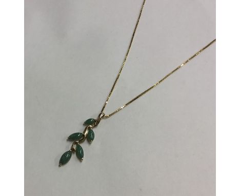 A heavy gold and jade pendant on fine link chain. Approx. 44.5 grams. Est. £70 - £80.