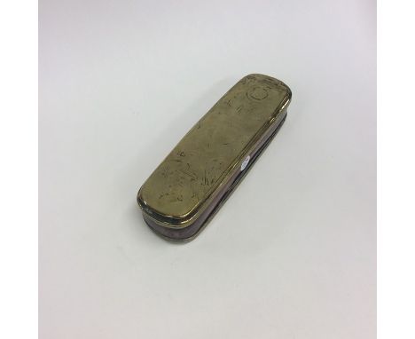 A large Georgian oval brass mounted snuff box with hinged lid. Approx. 16 cms long. Est. £40 - £50.