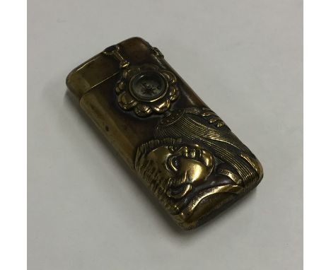 A Japanese brass Art Nouveau vesta case inset with compass. Approx. 25 grams. Est. £30 - £50.