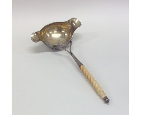 An unusual Continental silver double lipped ladle with ivory twist handle. Approx. 85 grams. Est. £60 - £80.