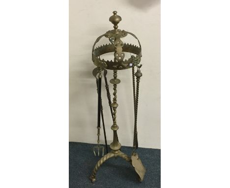 A tall brass companion set together with a toasting fork with telescopic handle. Est. £25 - £35.
