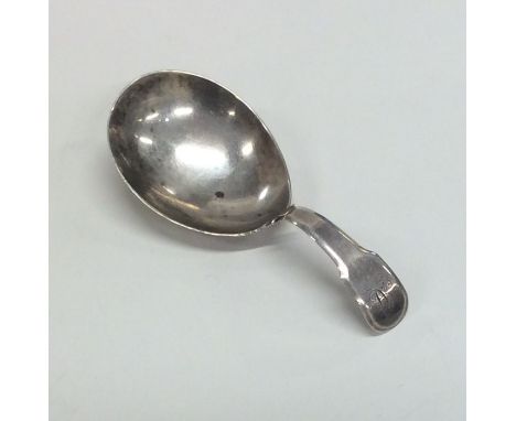 A large heavy fiddle pattern silver caddy spoon. London. By JS. Approx. 10.5 grams. Est. £30 - £40.