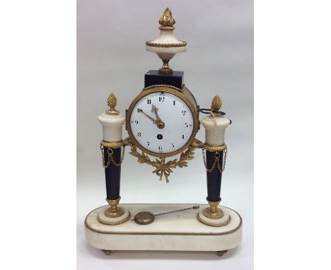 A French mantle clock with white enamel dial on oval base. Est. £100 - £150.