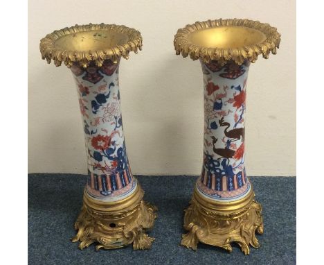 A good pair of brass vases / lamp bases of Chinese design decorated in bright colours. Approx. 36.5 cms high. Est. £250 - £35