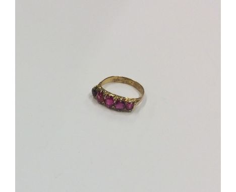 An Antique ruby five stone half hoop ring in claw mount. Approx. 2.1 grams. Est. £150 - £200.