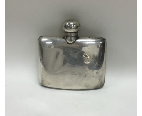 A hinged top kidney shaped silver hip flask with screw-on cover. Approx. 90 grams. Est. £60 - £80.