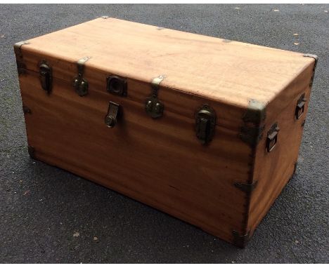 A hinged top camphor wood trunk mounted with carrying handles. Est. £200 - £300.