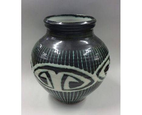 RAY MARSHALL: A green ground pottery vase of baluster form. SIgned to base. Approx. 23 cms high. Est. £30 - £50.