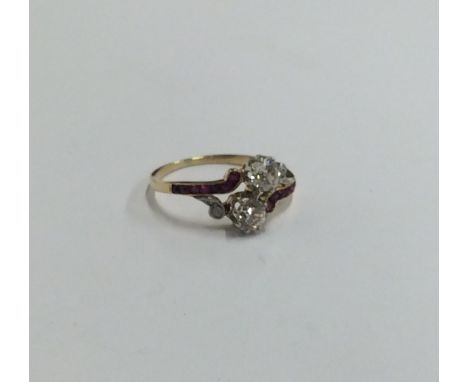 A Continental ruby and diamond two stone crossover ring. Approx. 2.7 grams. Est. £400 - £600.