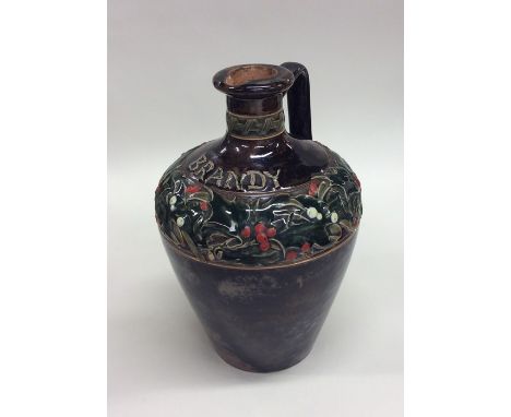 A Royal Doulton Christmas brandy flask decorated with holly and berries. Est. £40 - £60.