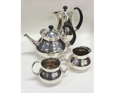 A stylish silver plated four piece tea service with ebony handles. Est. £30 - £50.