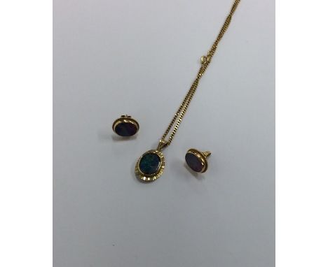 A large opal oval pendant on fine link chain together with matching earrings. Approx. 13 grams. Est. £150 - £200.