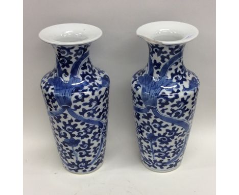 A pair of Chinese blue and white vases with tapering bodies. Seal marks to bases. Est. £50 - £80.