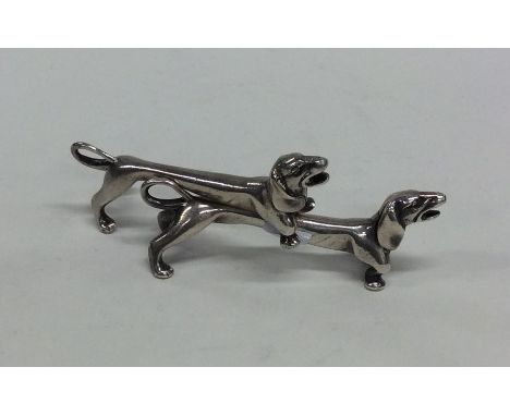 A pair of novelty silver knife rests in the form of sausage dogs. Sheffield. By SH Ltd. Approx. 95 grams. Est. £50 - £80.