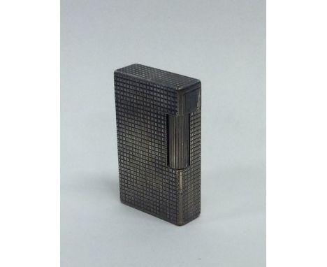 An engine turned lighter by Dupont of Paris. Approx. 90 grams. Est. £30 - £50.
