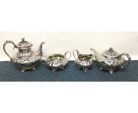 A good quality four piece silver tea and coffee service, the body attractively decorated with flowers and leaves to panelled 