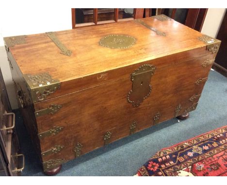 A massive Continental trunk mounted with brass strap work to bun feet revealing a hinged interior. Approx. 70 cms high x 59 c